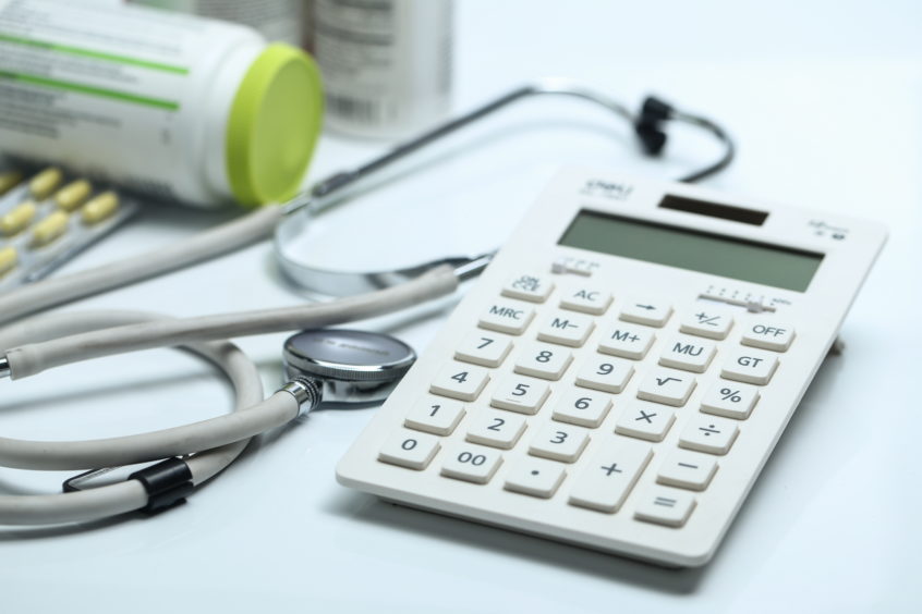 Medical bills car accident settlement - Calculator, stethoscope, and medicine bottles