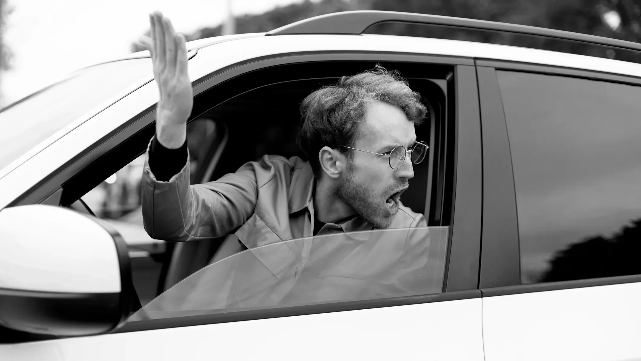 Angry driver yelling out of car window