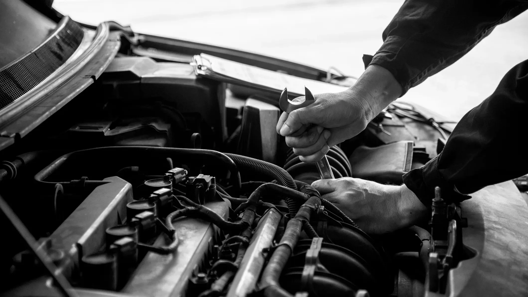 mechanic working on car engine